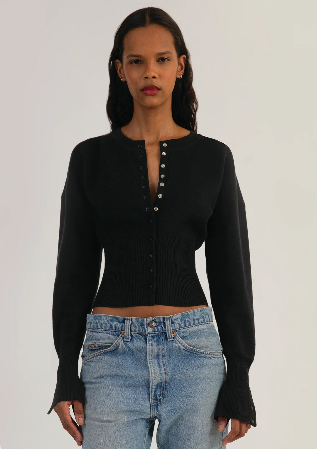 Casual yet chic women's cropped knit cardigan. Fitted, long sleeve, and button-up for easy styling.