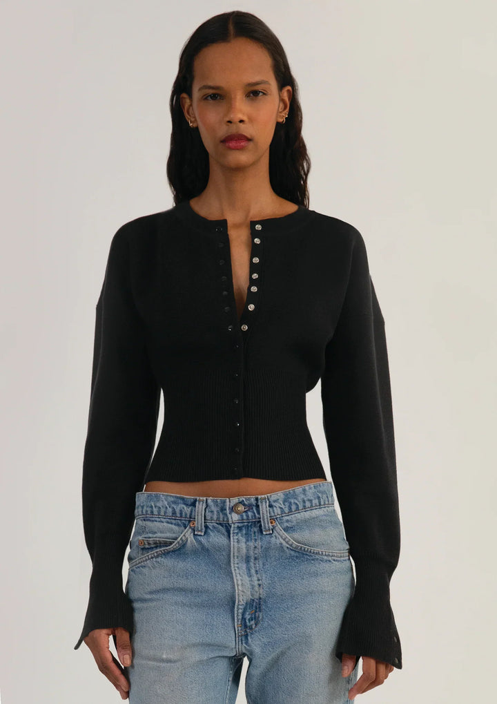 Casual yet chic women's cropped knit cardigan. Fitted, long sleeve, and button-up for easy styling.