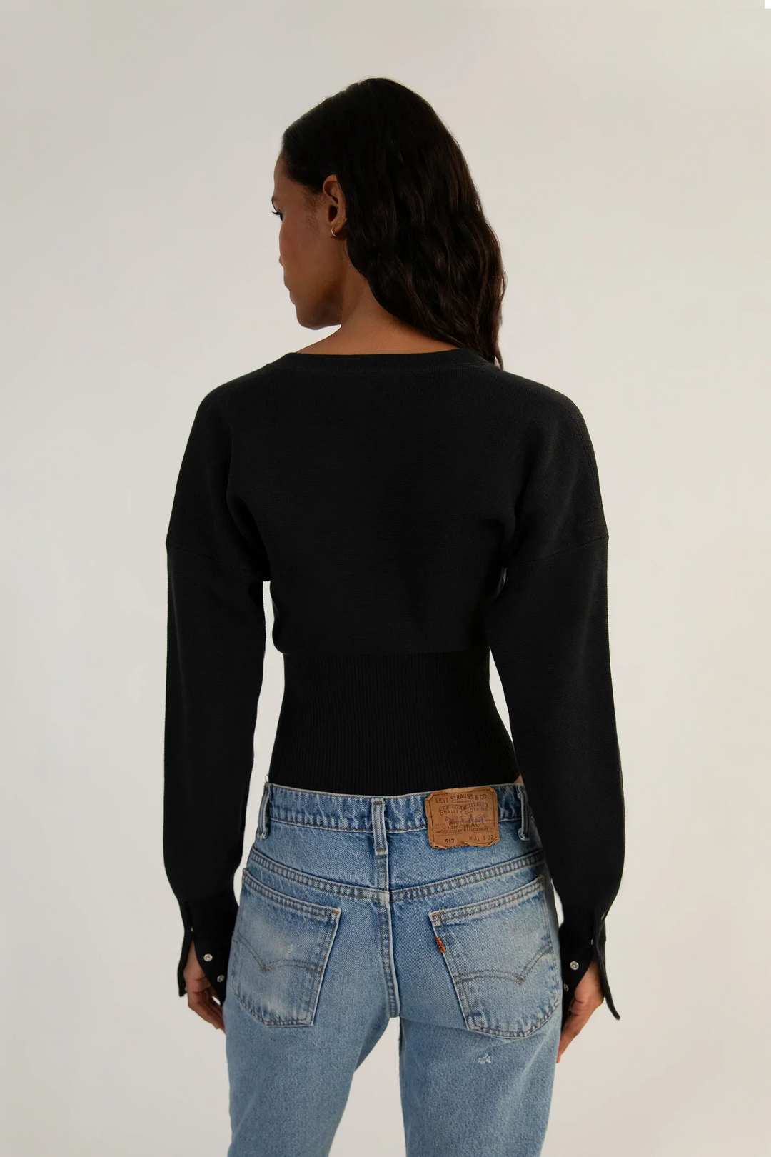 Modern women's fitted long sleeve cropped cardigan with stylish button-up front. Versatile layering top.