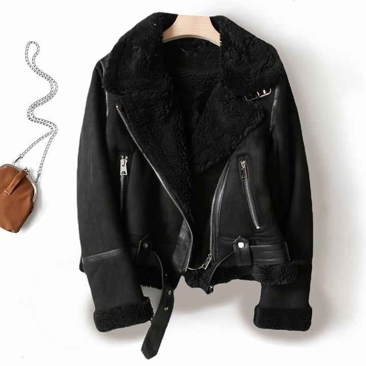 Close-up of women's black faux shearling biker jacket showing texture and zipper detail, warm winter coat