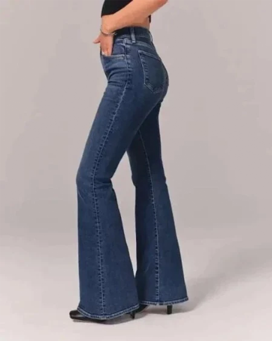 Back view of women's high-waisted flared denim jeans in light blue, featuring pockets