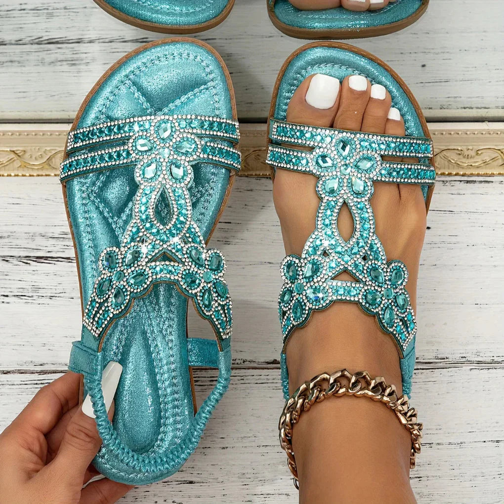Elegant women's flat sandals with detailed floral patterns, suitable for everyday wear