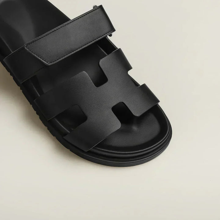 Tan women's flat sandals, adjustable strap, ideal for beach or everyday summer footwear.