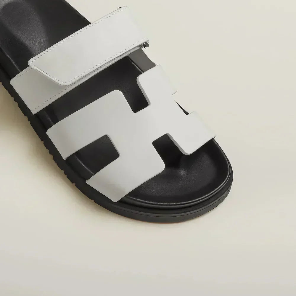 Woman wearing brown adjustable strap flat sandals, showcasing comfortable everyday footwear.
