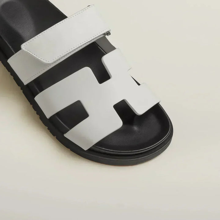 Woman wearing brown adjustable strap flat sandals, showcasing comfortable everyday footwear.