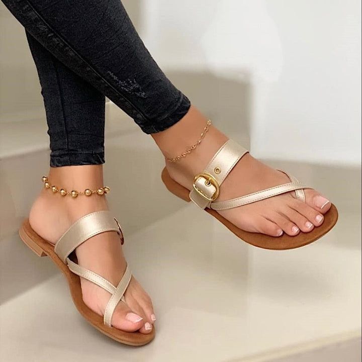 Chic women's flat buckle sandals for everyday comfort. Open-toe, lightweight design ideal for walking & beach.