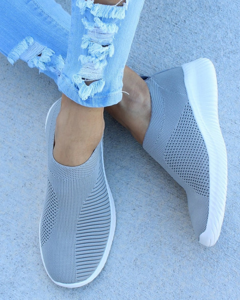 Close-up of women's knit athletic footwear, showcasing the breathable fabric and flexible design