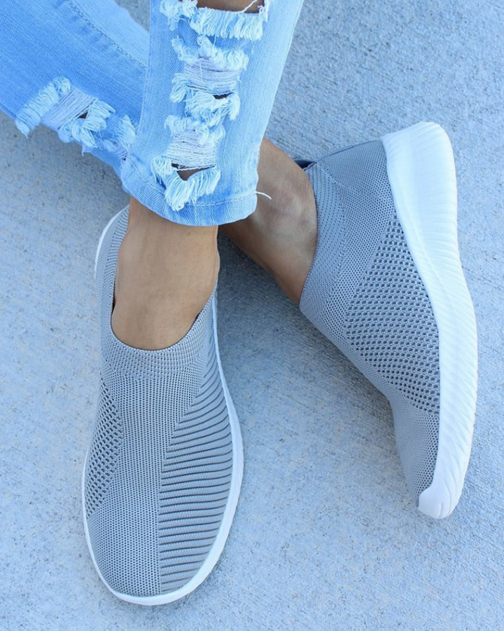 Close-up of women's knit athletic footwear, showcasing the breathable fabric and flexible design