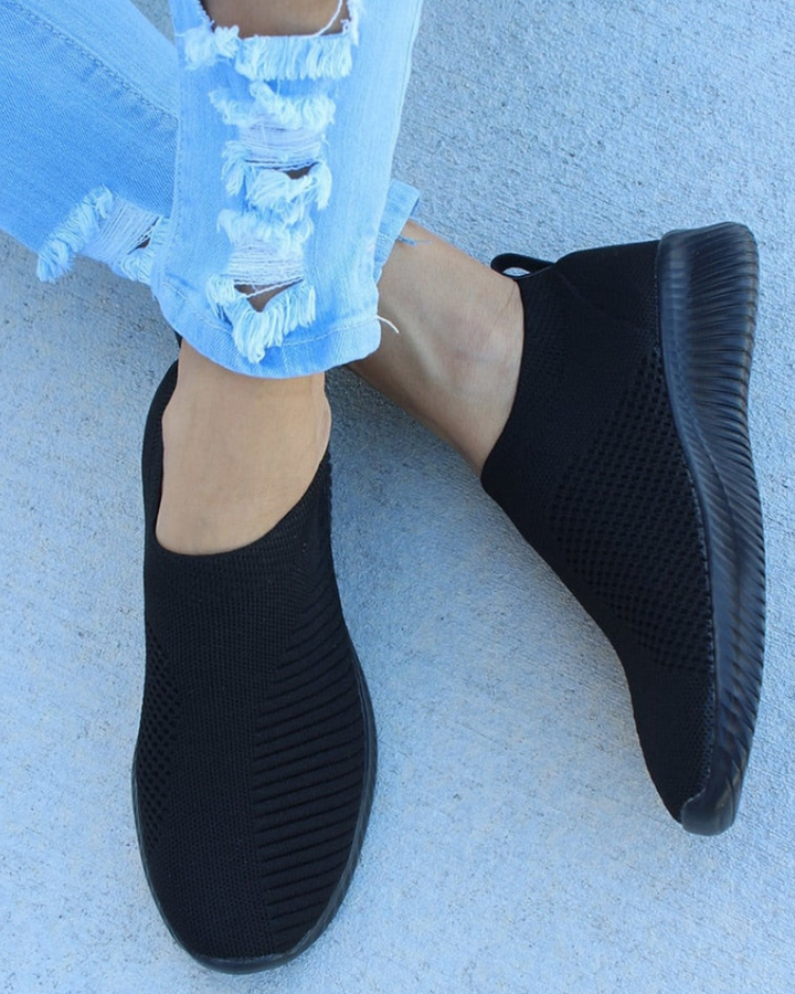 Stylish black women's flexible knit running shoes with a durable sole, suitable for all-day comfort