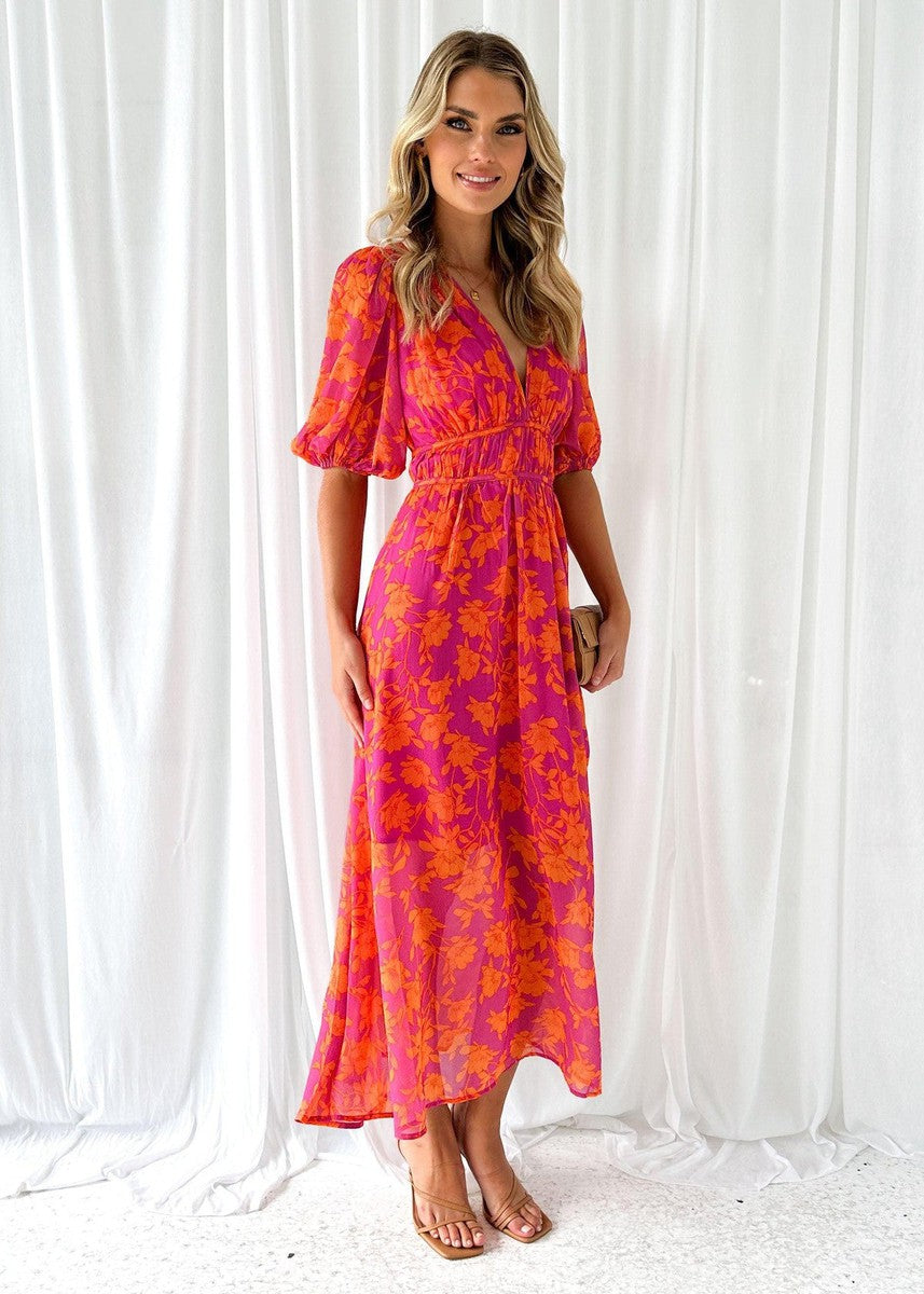 Close-up of a women's floral midi dress fabric, pink and orange summer style, v-neck detail