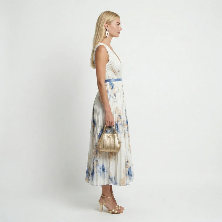 Flowy white women's floral pleated maxi dress with sleeveless V-neck, a chic choice for summer elegance.