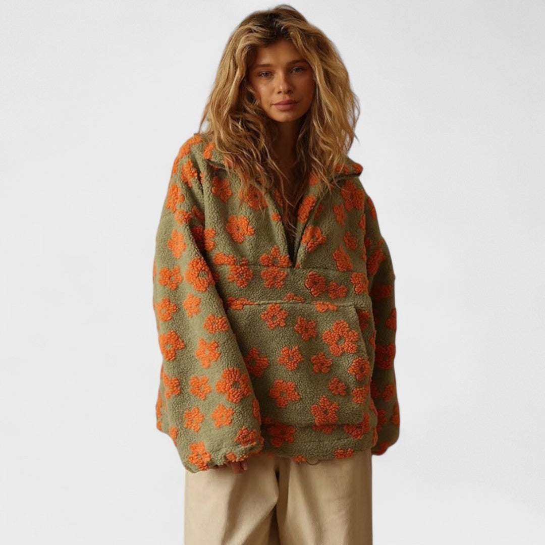 Close-up of a women's polar fleece pullover with intricate floral print