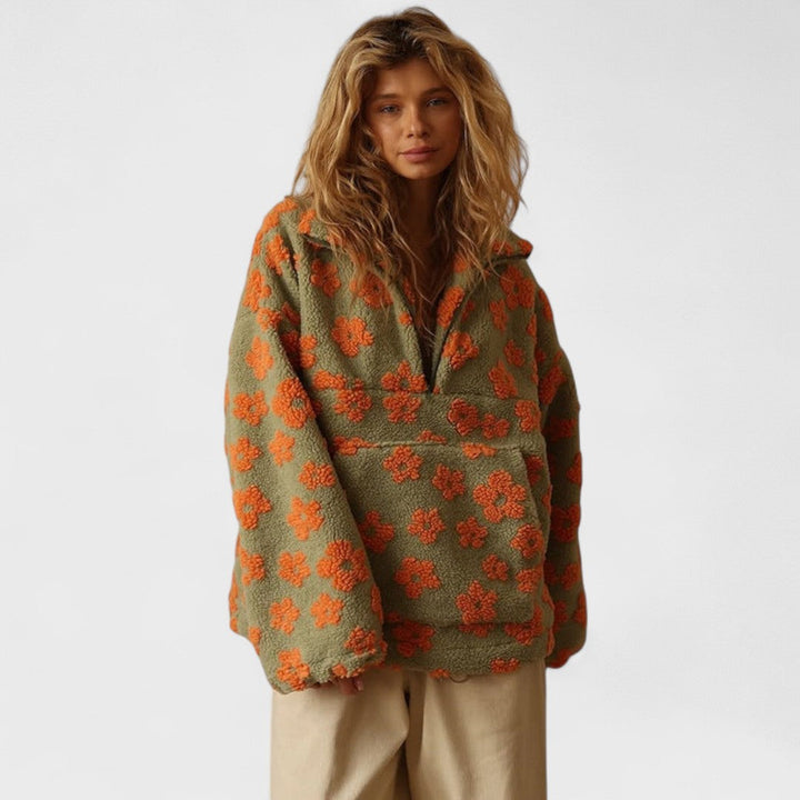 Close-up of a women's polar fleece pullover with intricate floral print