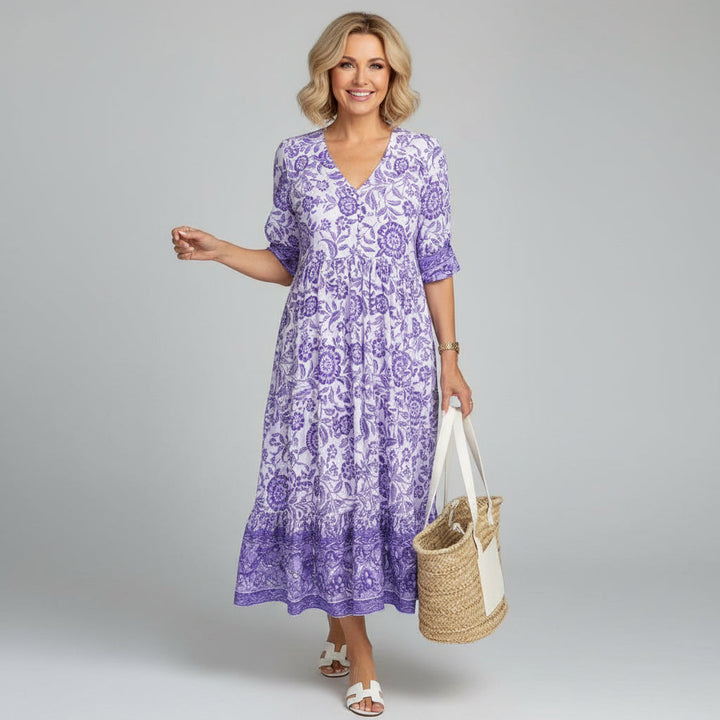 Elegant women's tiered floral midi dress featuring V-neck and 3/4 sleeves for a chic summer look.