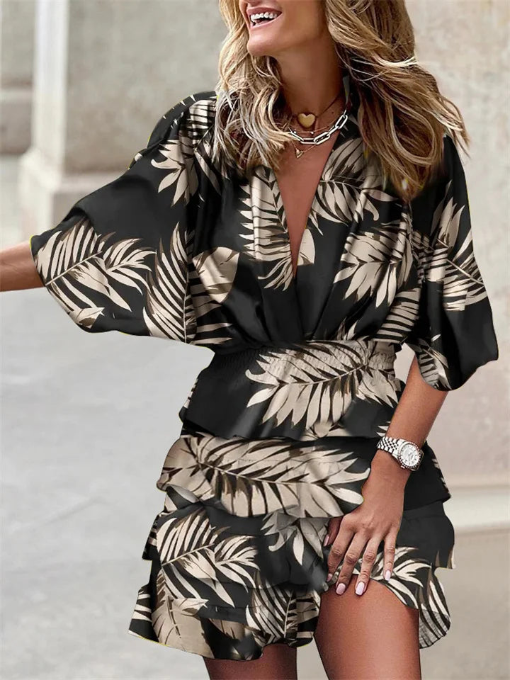 Stylish women's mini dress showcasing a floral pattern, V-neckline, ruffles, & trendy batwing sleeves. Casual elegance.