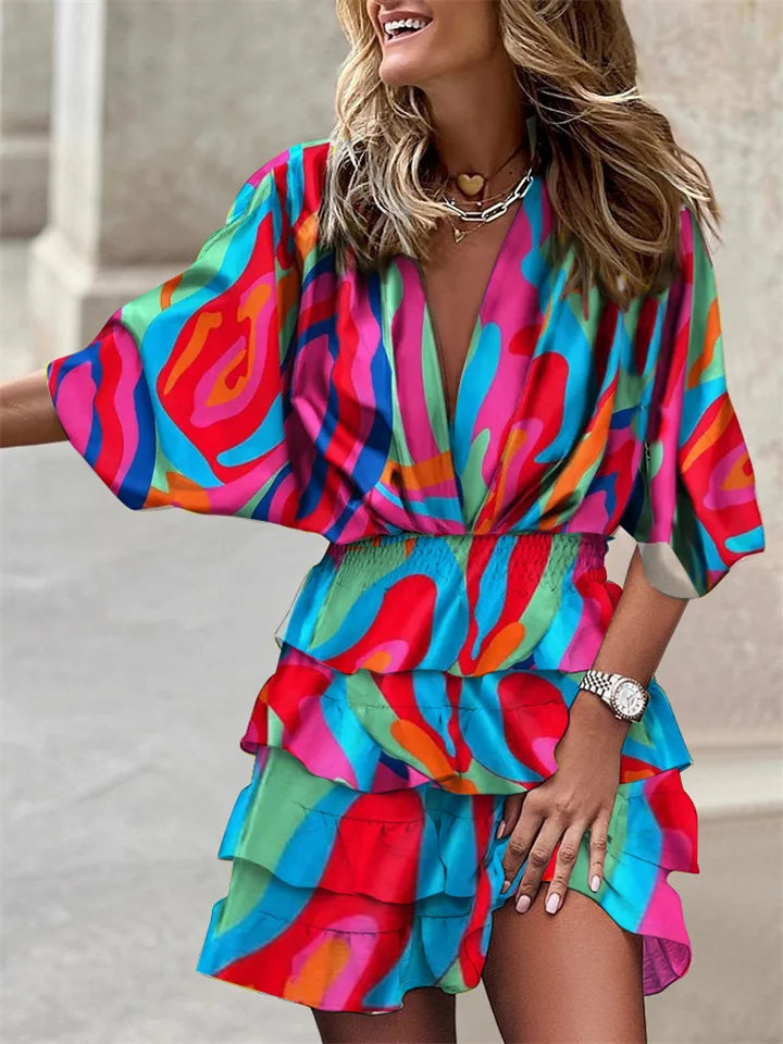 Vibrant floral V-neck mini dress for women, featuring delicate ruffles and fashionable batwing sleeves. Perfect for casual spring.