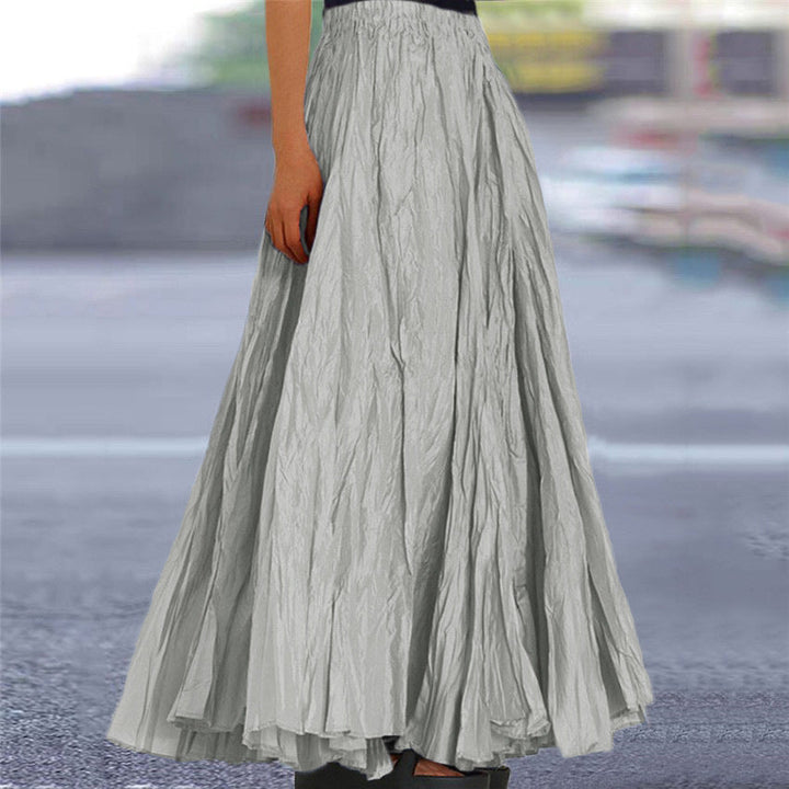 Beige pleated long skirt for women, featuring a comfortable elastic waist and flowy A-line cut.