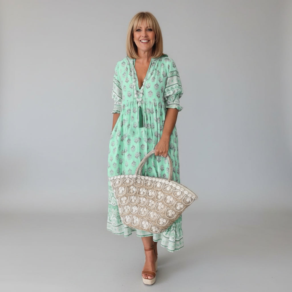 Women's flowy midi dress in a relaxed fit, perfect for summer. Features short sleeves & elegant, comfortable style.
