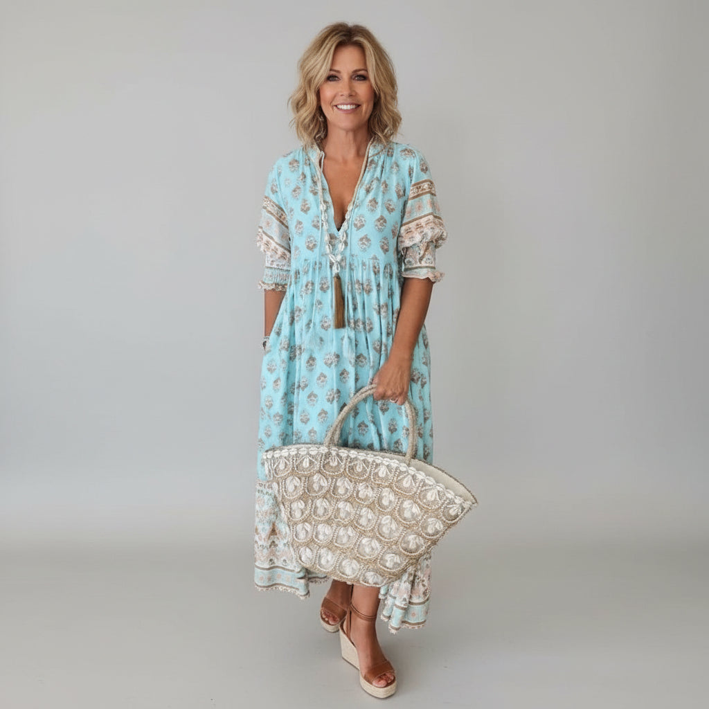 Effortless women's midi dress, ideal for summer vacations or casual parties. Flowy, comfortable, and chic.