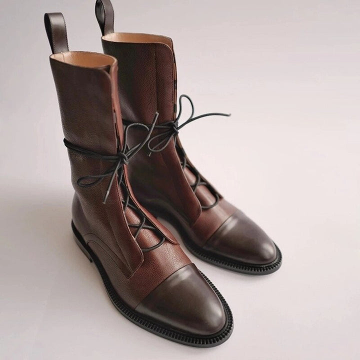 Elegant women's lace-up ankle boots in classic black, ideal for formal wear and professional settings.