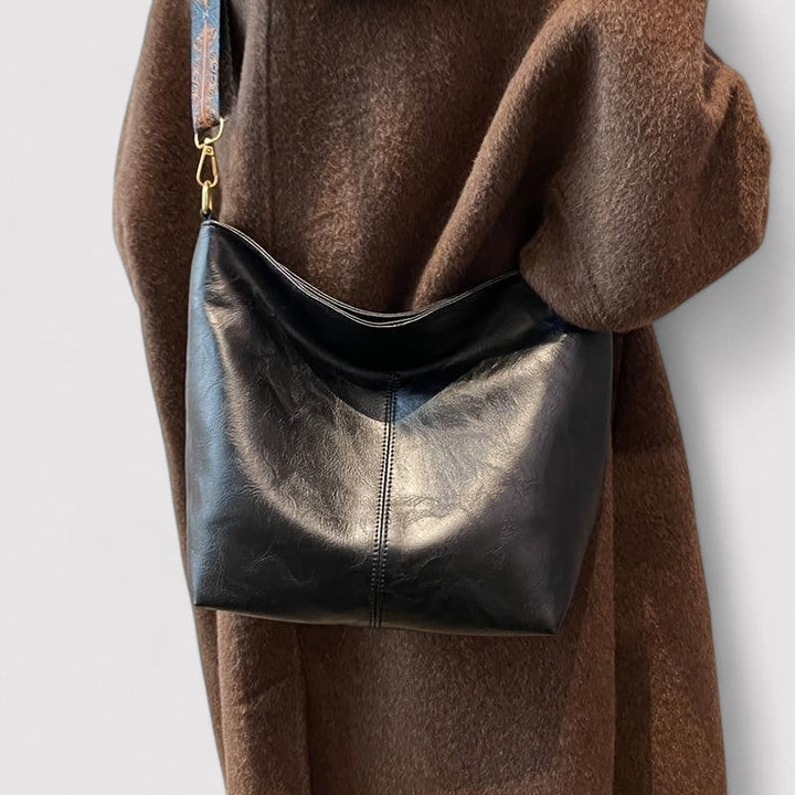 Stylish women's leather hobo bag with adjustable strap, perfect for crossbody wear