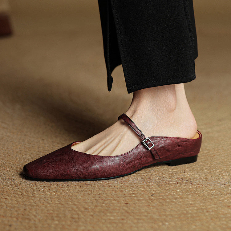 Front view of women's leather mules, elegant slip-on shoes for various occasions