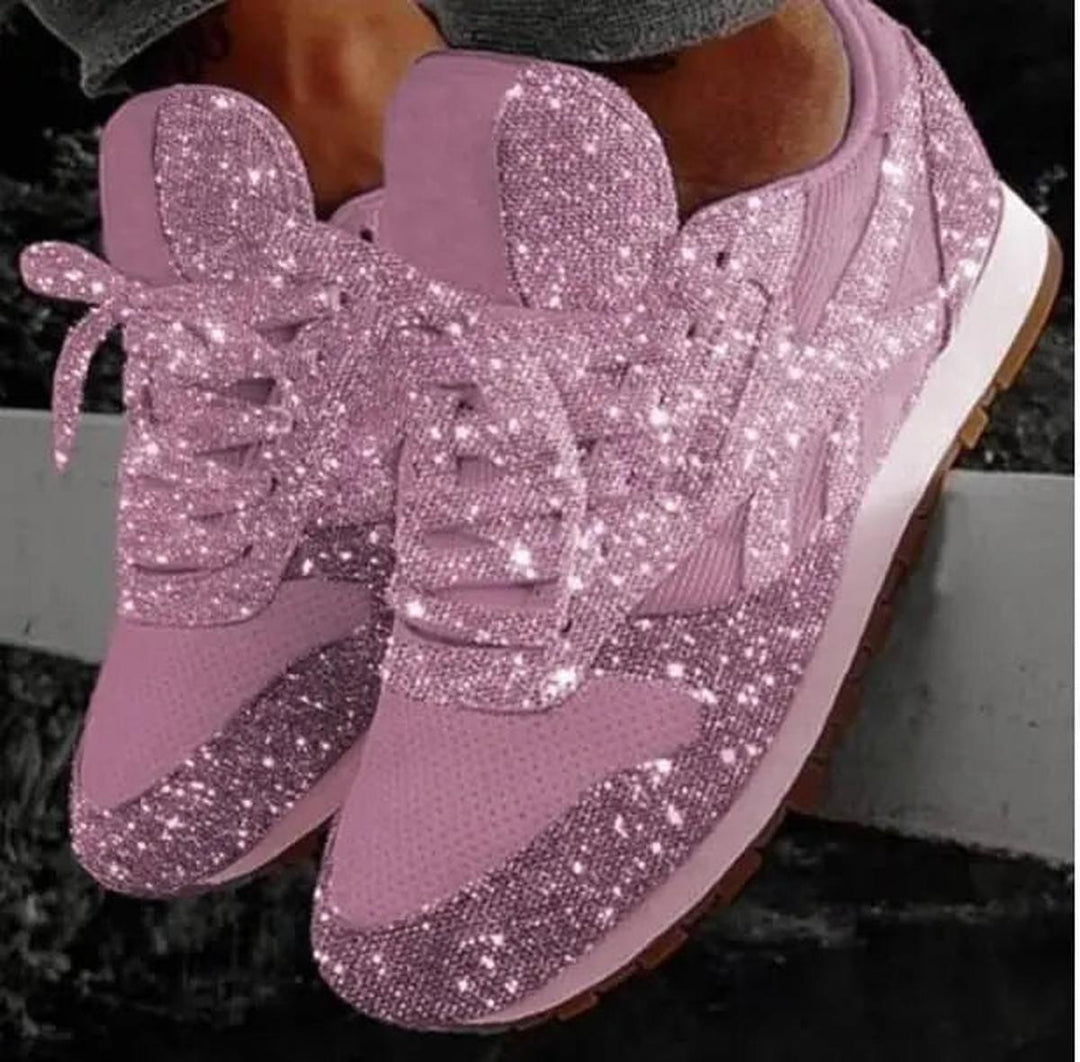 Close-up of women's metallic glitter lace-up trainers, perfect for sparkling casual wear footwear