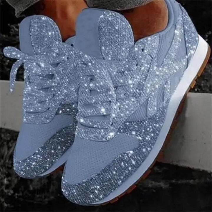 Pair of women's sparkly lace-up trainers, offering comfort and glamour for everyday fashion