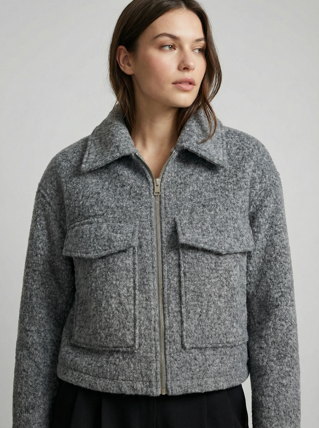 Women's gray cropped zip jacket with stylish front pockets. Perfect for versatile layering.