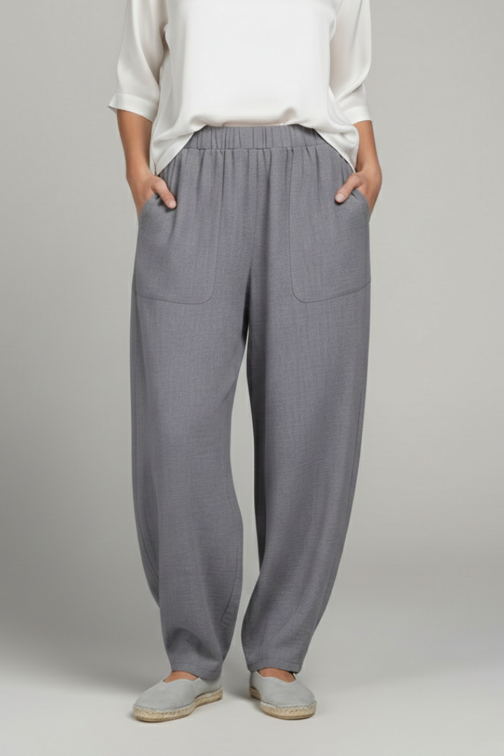 Relaxed fit grey women's trousers with an elastic waistband and side pockets, ideal for comfort.