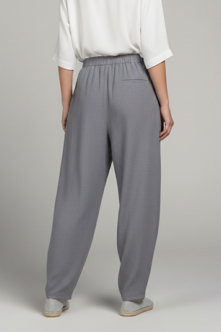 Soft grey women's apparel: elastic waist trousers with essential side pockets for versatile styling.