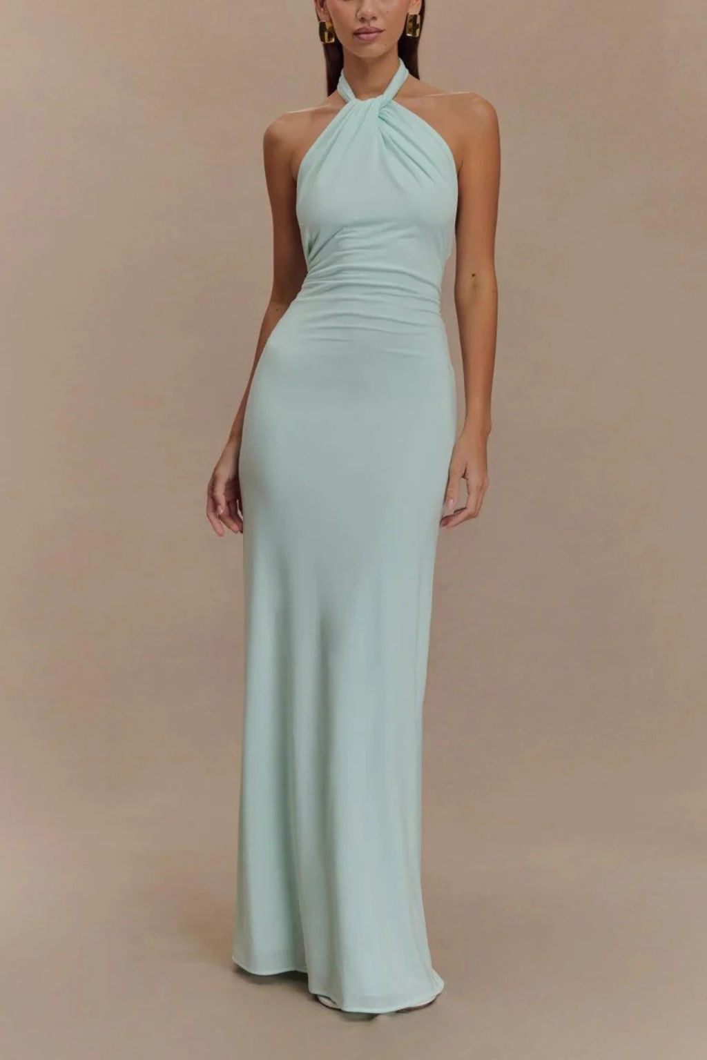 Chic halter bodycon maxi dress for wedding guests. Features open back & elegant twisted knot design.