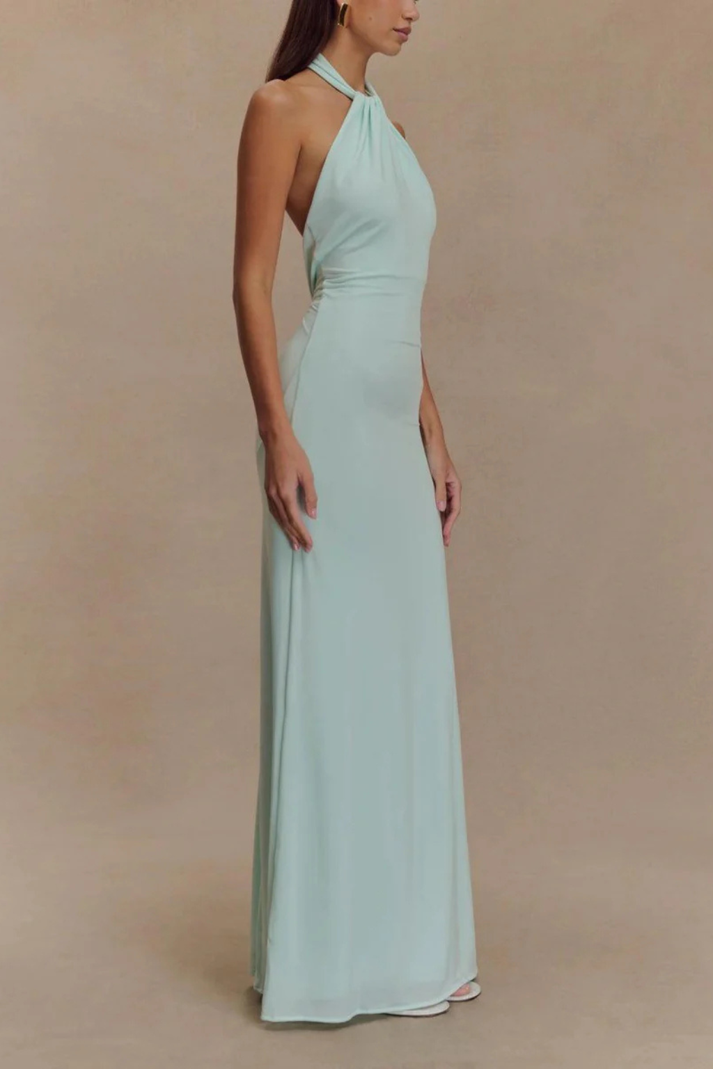 Slimming bodycon maxi dress with stylish halter neck. Open back and twisted knot detail for formal events.