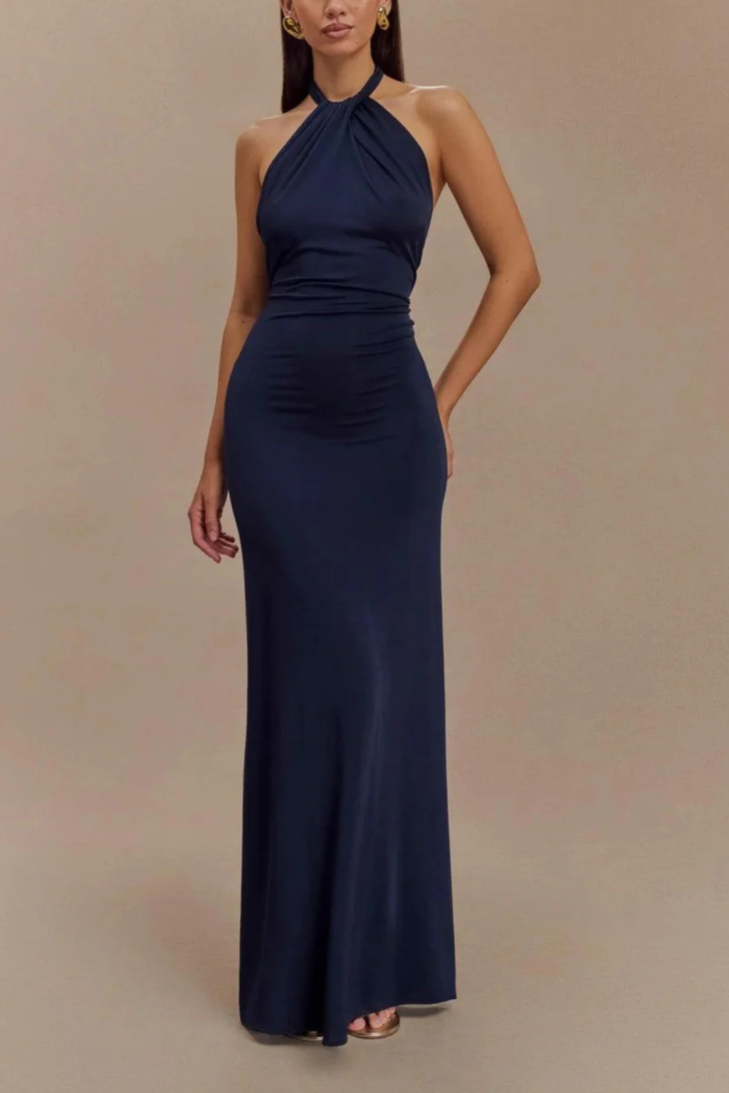 Formal halter neck maxi dress with a flattering bodycon fit. Elegant open back and twisted knot design.