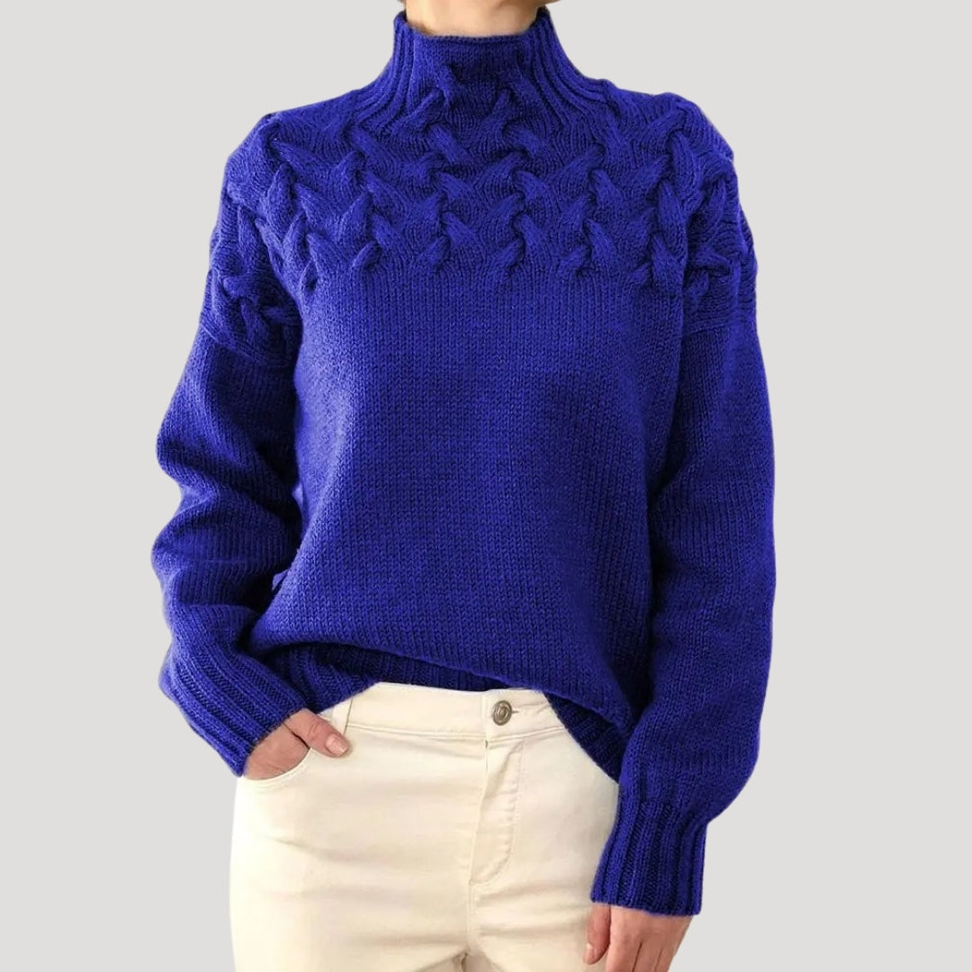 Stylish women's cable knit pullover with a cozy high neck, ideal for spring fashion trends.