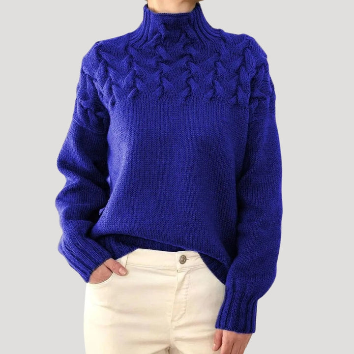 Stylish women's cable knit pullover with a cozy high neck, ideal for spring fashion trends.
