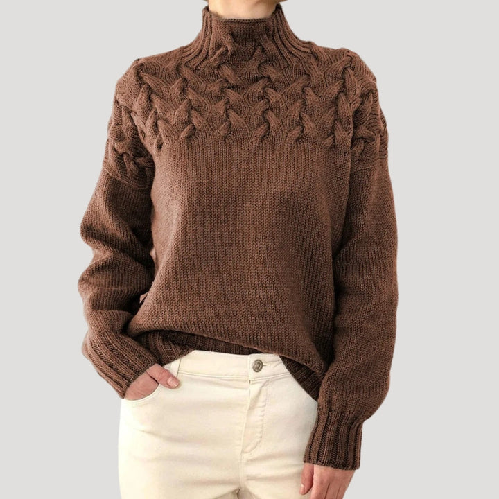 Versatile women's cable knit sweater with a high neck, a perfect addition to any spring wardrobe.