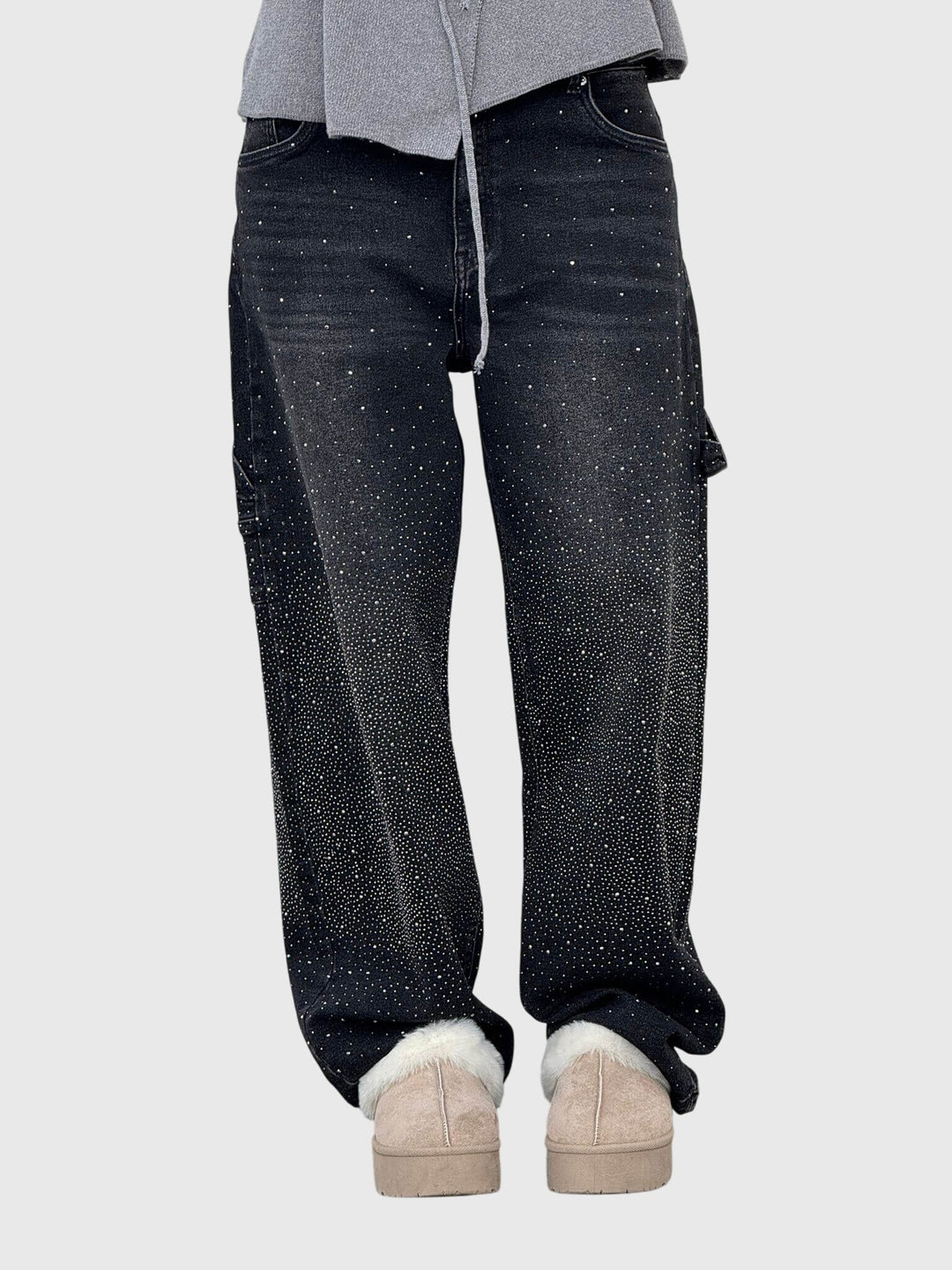 Side profile of women's wide-leg denim sparkling pants, showcasing the cut and diamond detail.