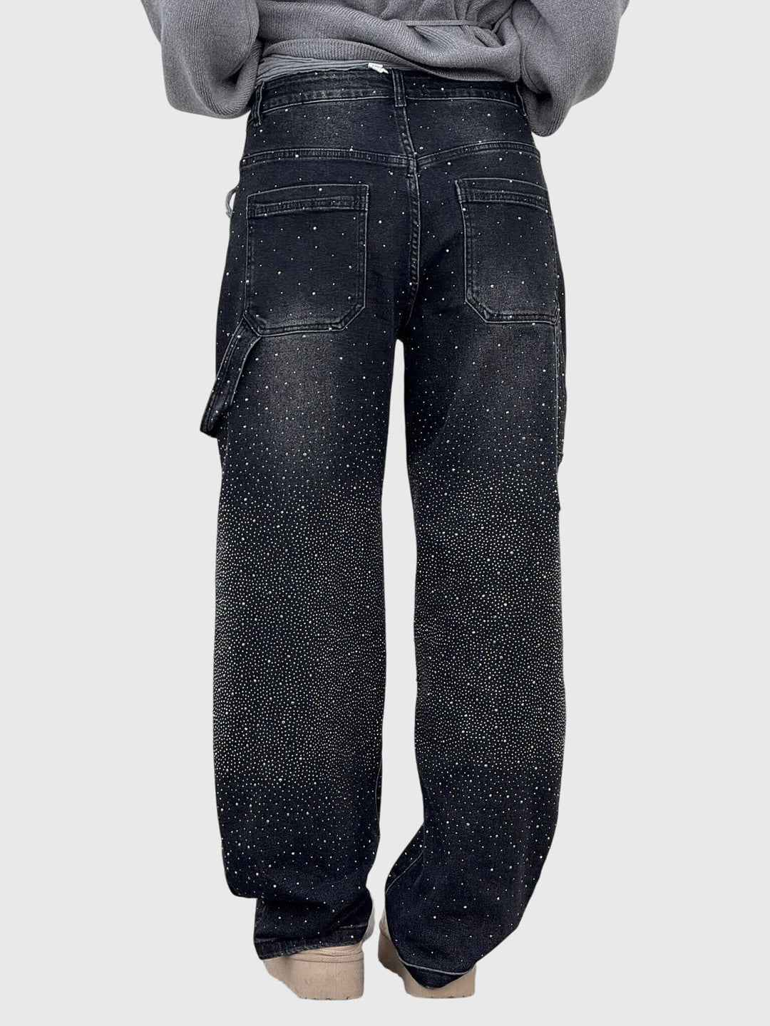 Hanging display of women's sparkle diamond wide-leg denim pants, ready for fashion.