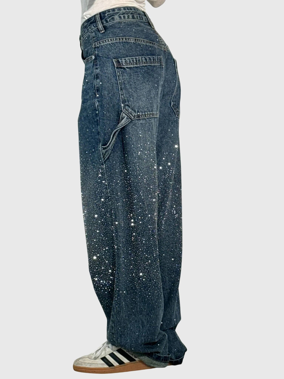 Close-up of diamond sparkle detailing on women's wide-leg denim casual fashion pants.