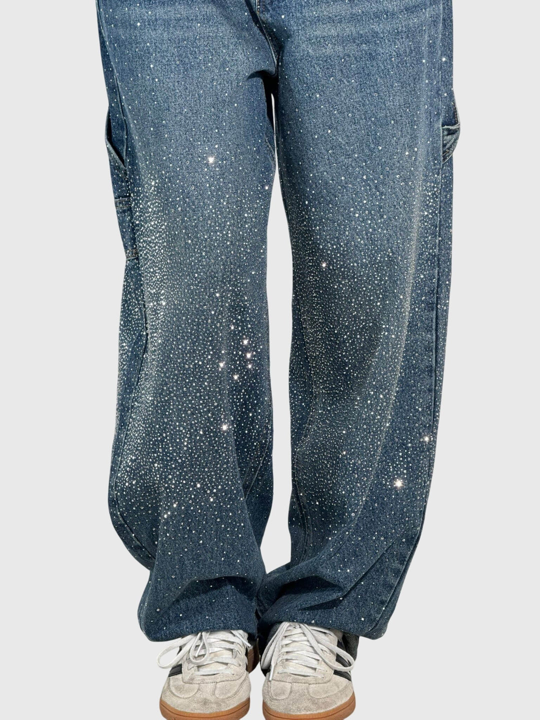 Model wearing women's sparkle wide-leg denim jeans, styled for a stylish casual look.
