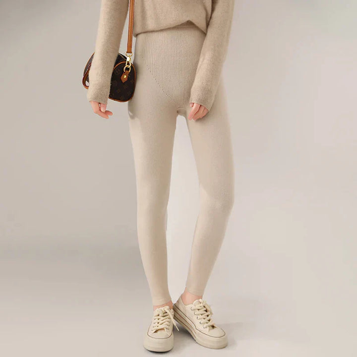 Fitted women's high-waist cashmere leggings, soft-touch fine knit for stylish winter outfits.