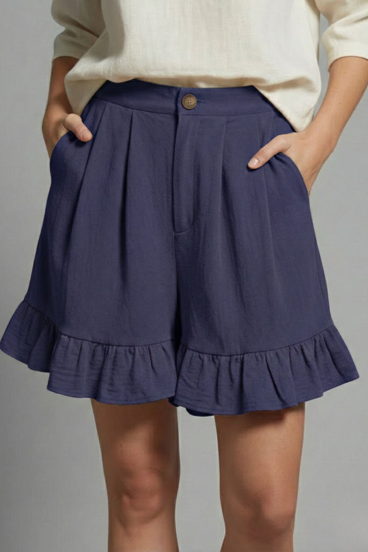 Women's high waist summer shorts in a pastel shade, showing the delicate ruffle details and casual elegance.