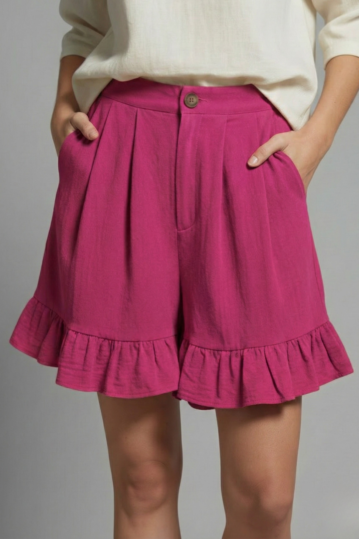 Studio shot of women's high waist ruffle shorts folded neatly, highlighting the quality and design for summer.