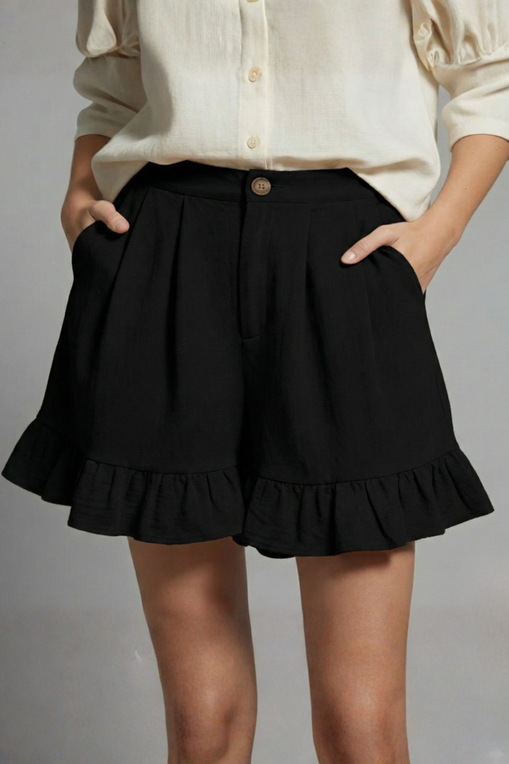 Detail shot of the elastic waistband and ruffle trim on women's high waist summer shorts, emphasizing comfort.