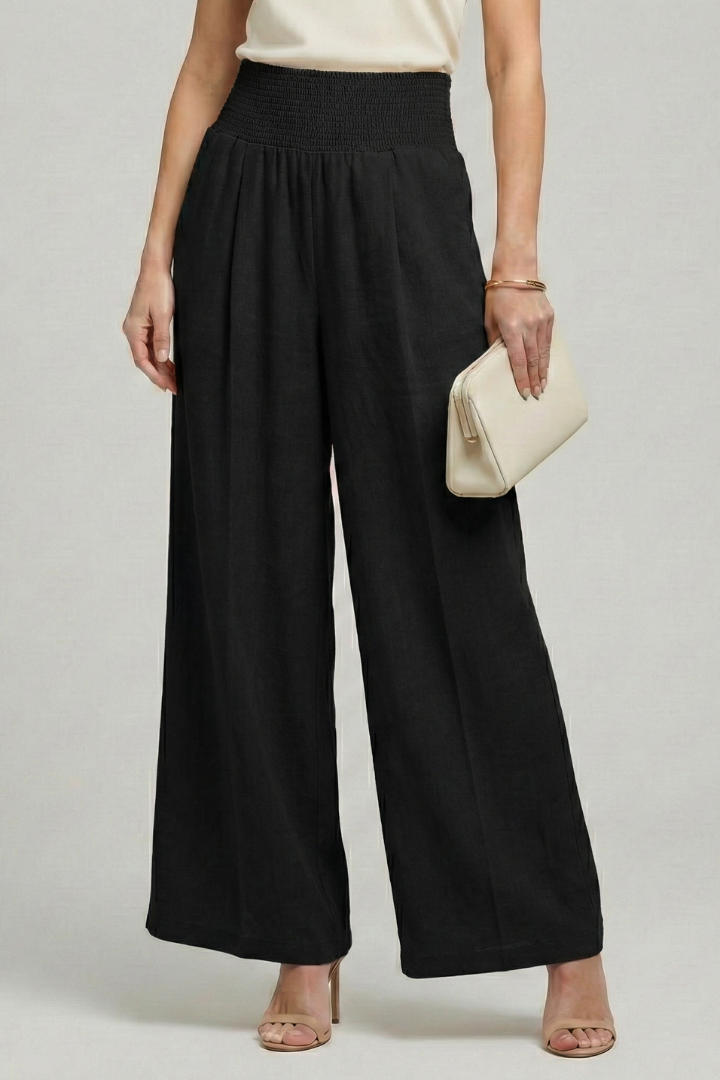 Stylish pleated palazzo trousers for women, featuring a high waist and wide-leg cut for summer comfort.