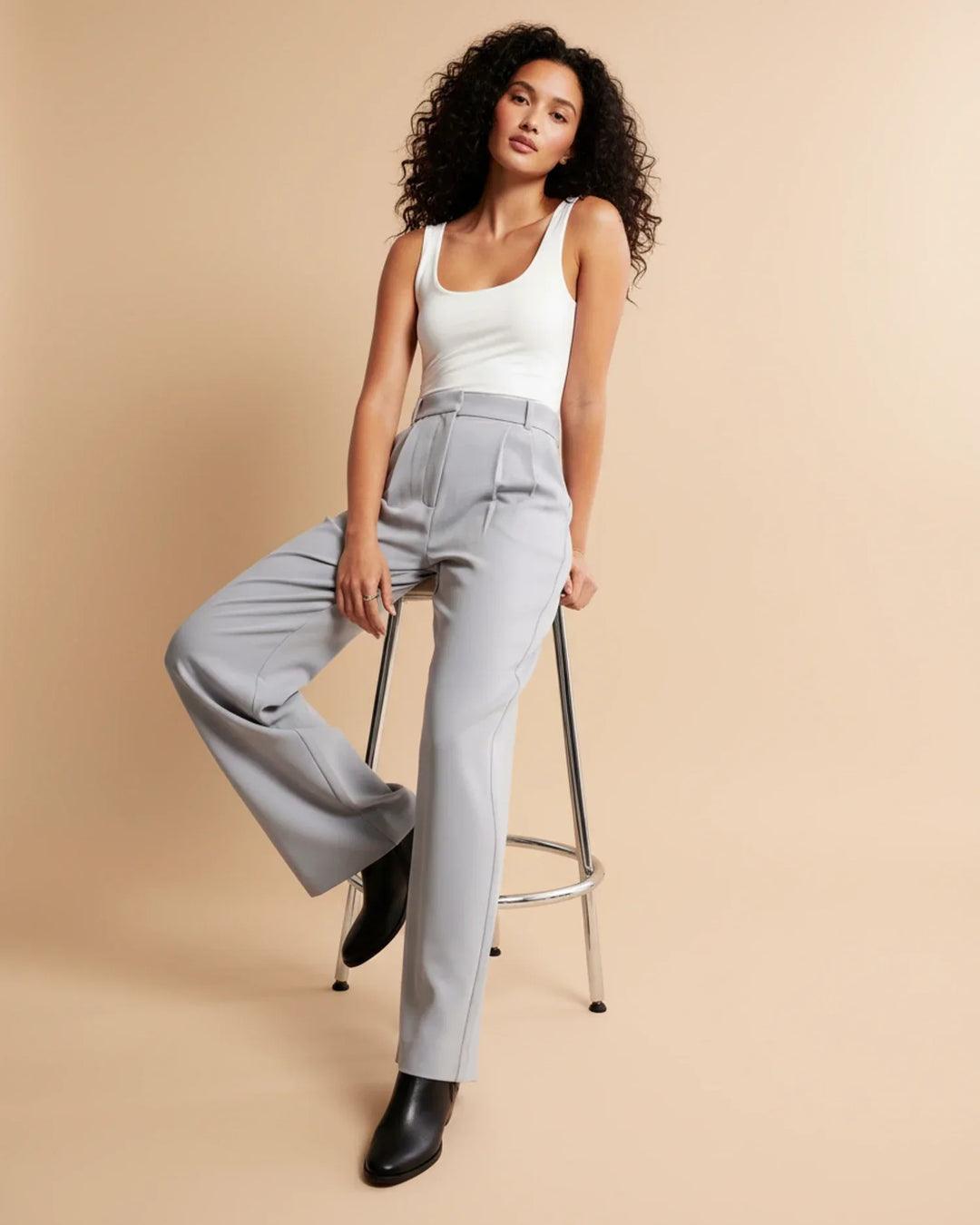 Sophisticated white high waist pleated tailored trousers for women, a modern officewear staple.