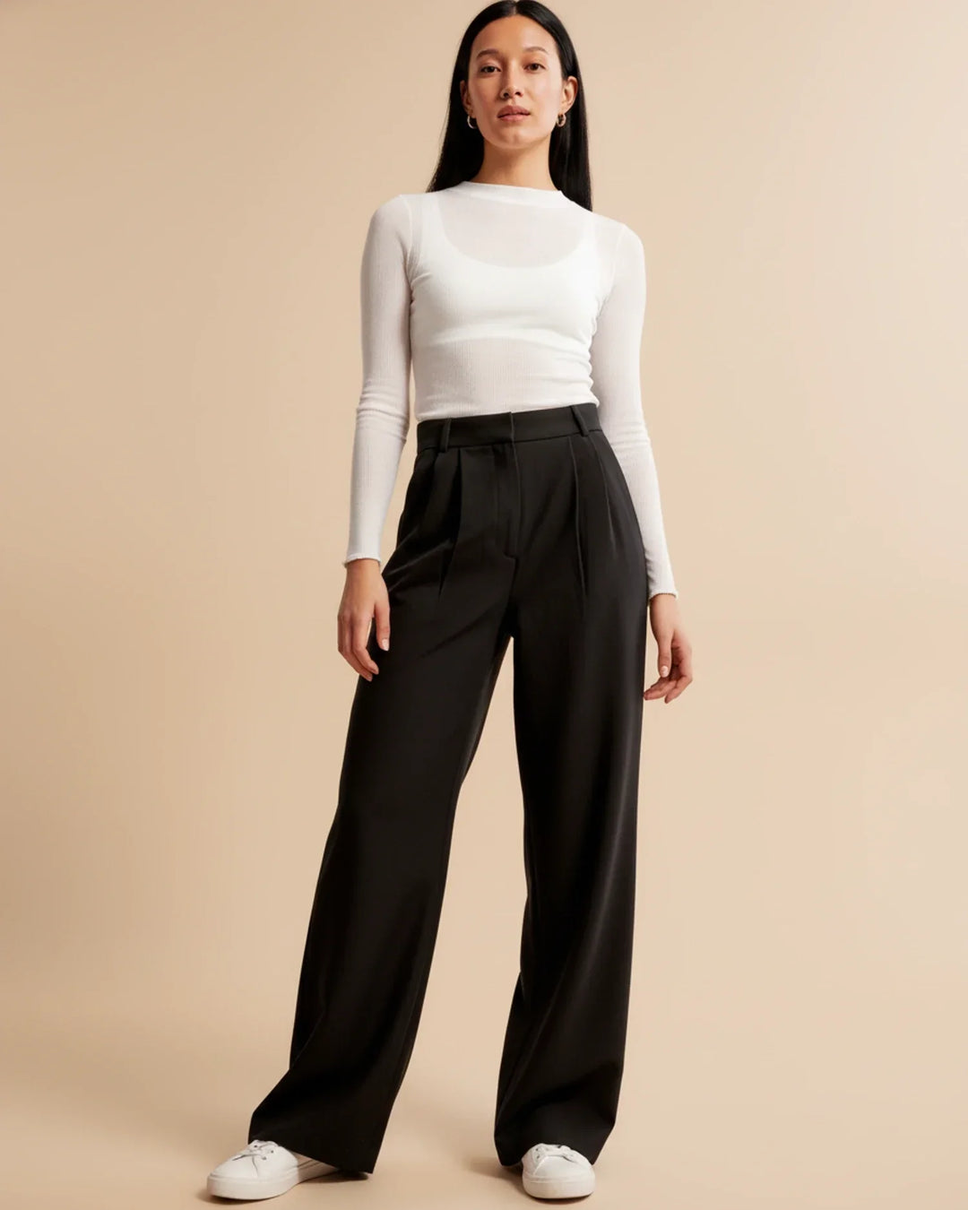 Front view of women's high-waisted pleated tailored trousers in a classic dark grey, versatile for any wardrobe.