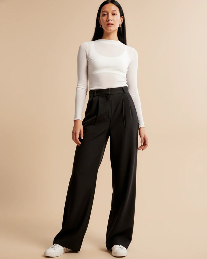 Front view of women's high-waisted pleated tailored trousers in a classic dark grey, versatile for any wardrobe.