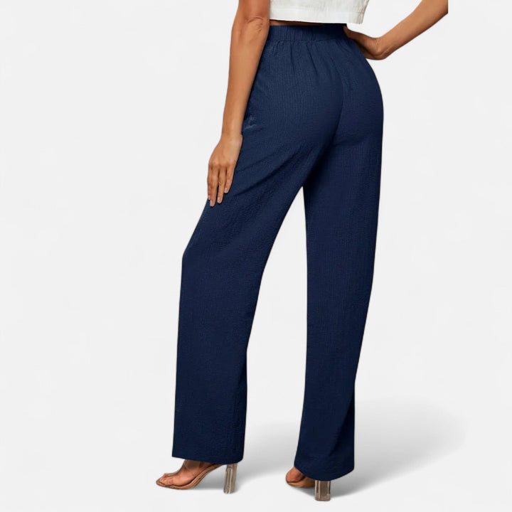 Sophisticated brown high-waist straight-leg trousers, essential for an elegant, tailored wardrobe.